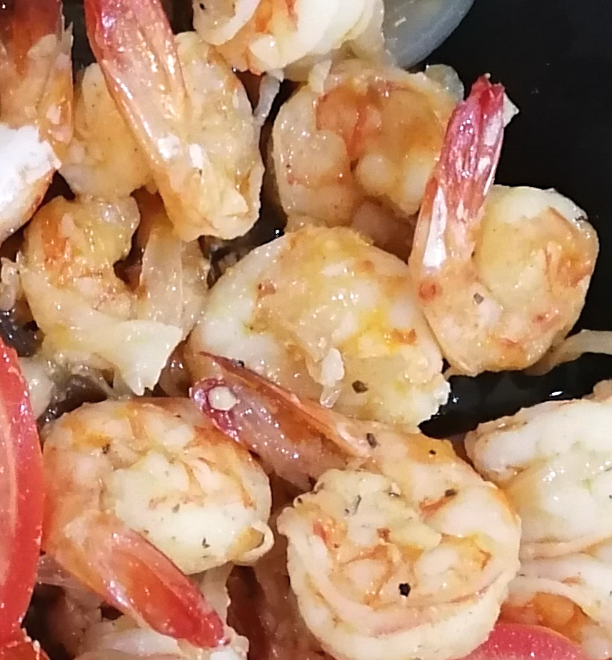 close up of garlic butter shrimp rwith garlic bits